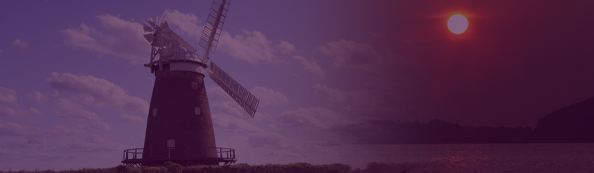 Windmill fading into sunset
